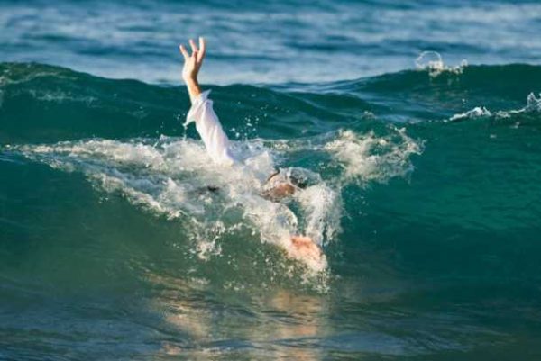 Businessman Drowning in Ocean