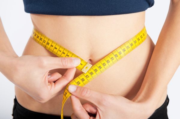 Slim waist with a tape measure around it